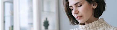 Pensive woman looking at mobile