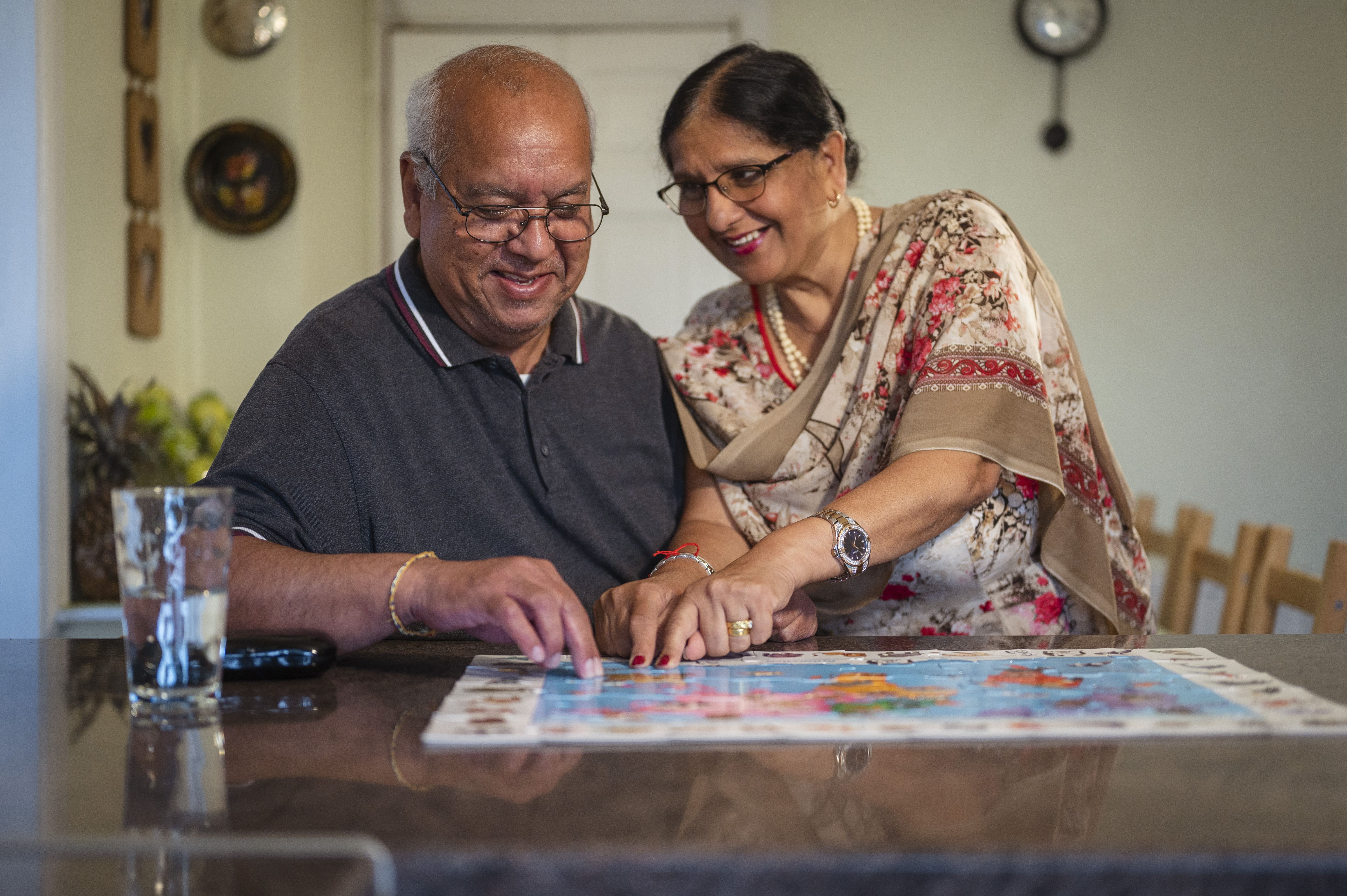 sikh couple filling in jigsaw