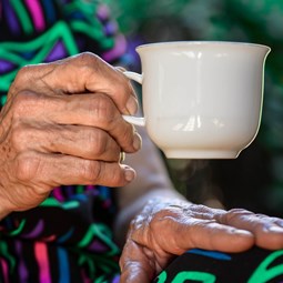 close up woman holding a teacup