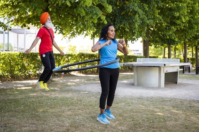 Two people exercising in a park