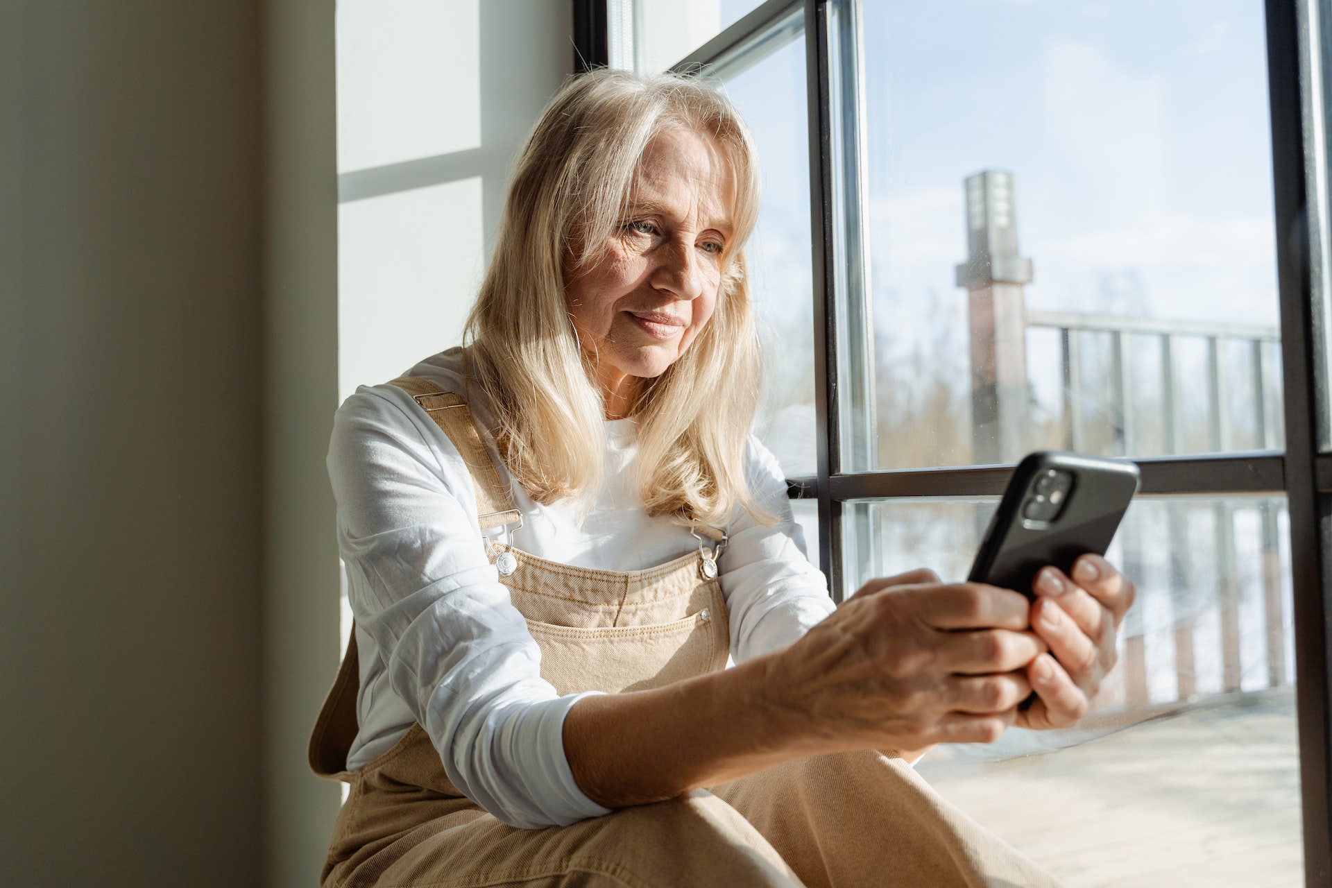 older woman looking at her phone