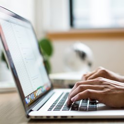 close up of a person using a laptop