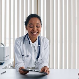 Smiling doctor at appointment with patient