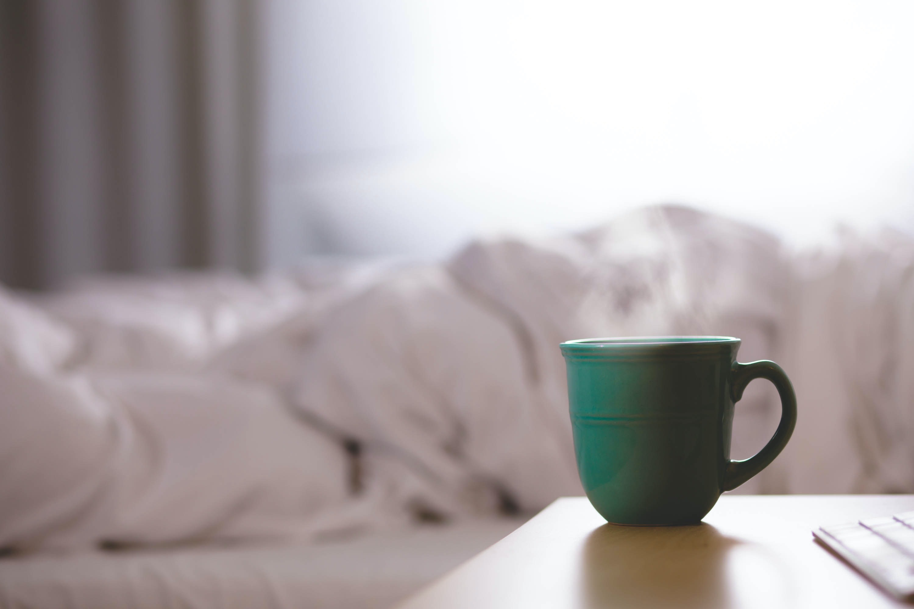 steaming mug next to bed