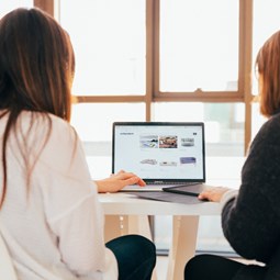 two people looking at computer, shot from behind