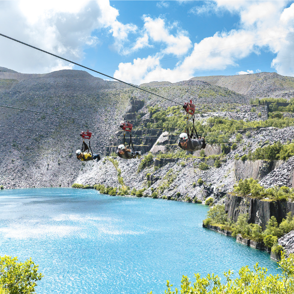 Participants on zip line over a quarry