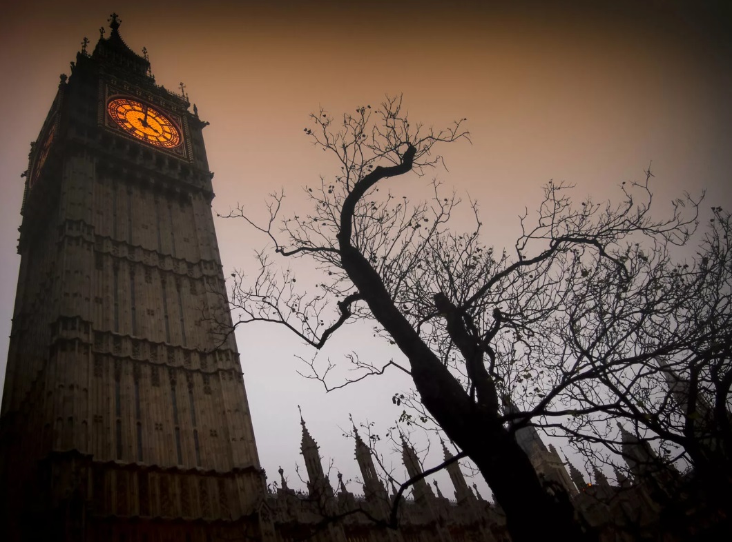 Big Ben orange clock face at dusk