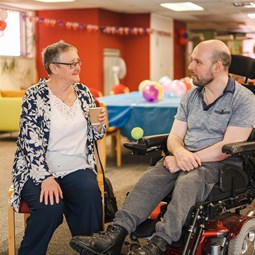 Two people talking at a carers centre.