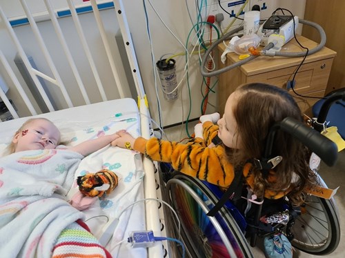 A photo of two children holding hands