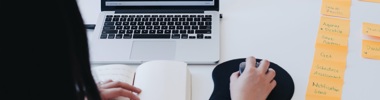 woman using a laptop with post it notes