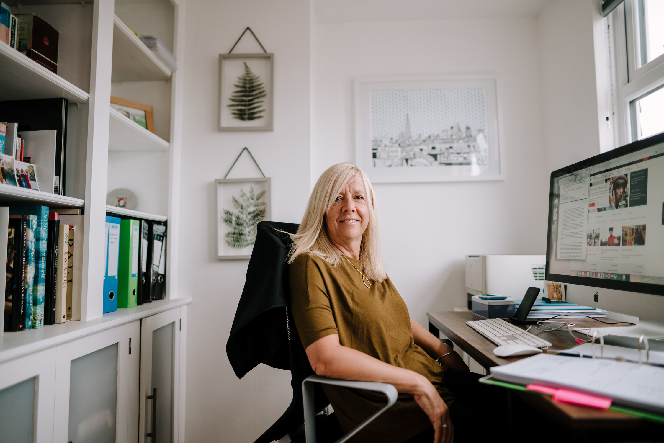 Woman in home office smiling