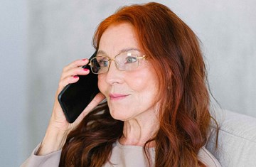 Woman in her 50s getting emotional support on the telephone
