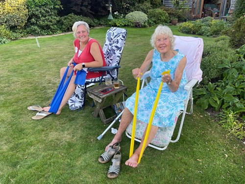 Image of two people sitting in lawn chairs