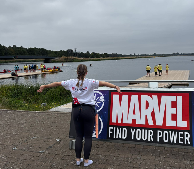 Participant standing by the side of a lake
