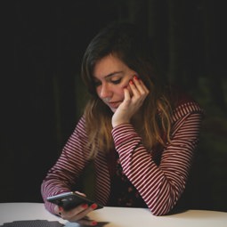 worried woman looking at mobile