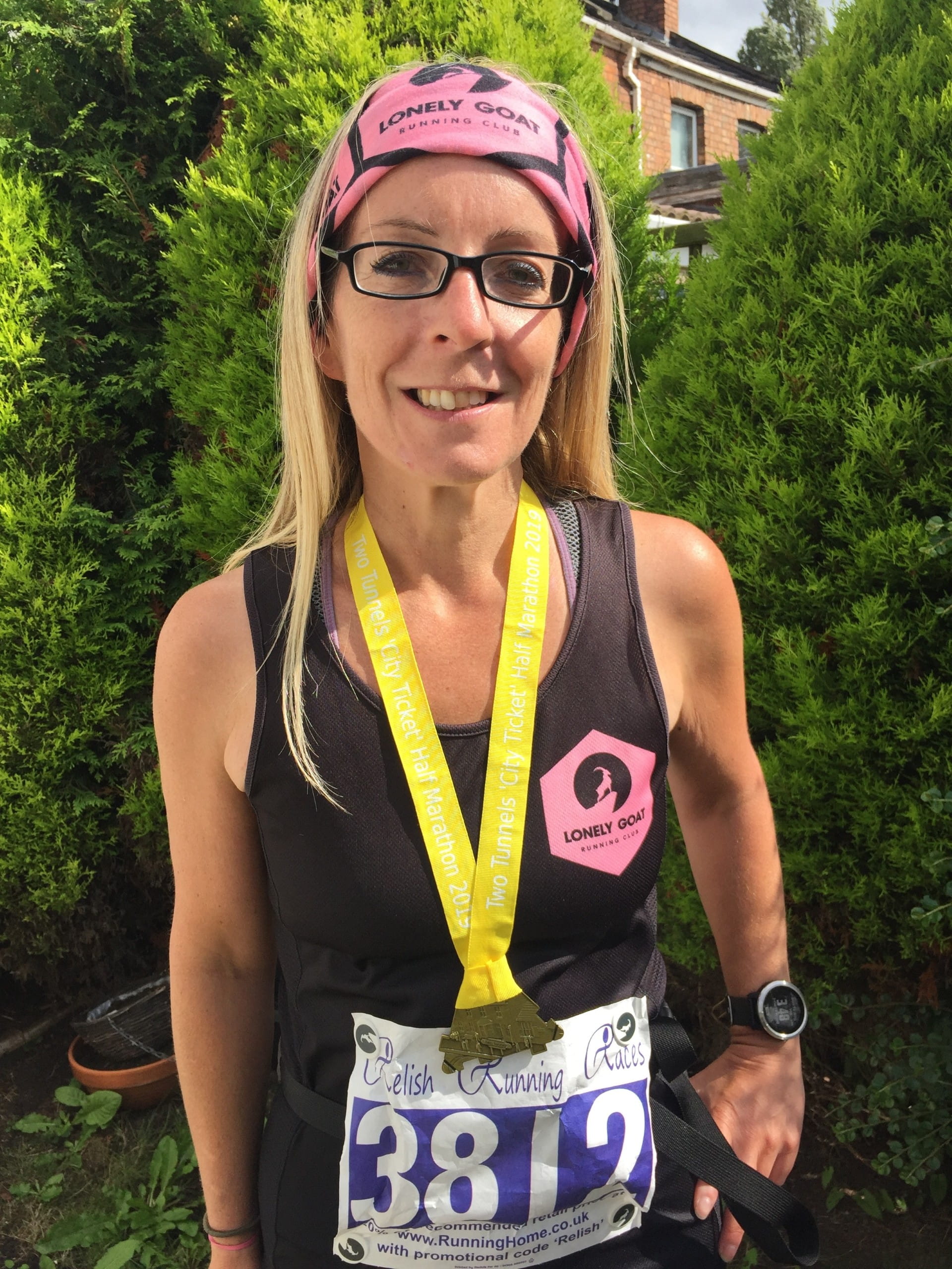 Anne Marie smiling with a medal around her neck.